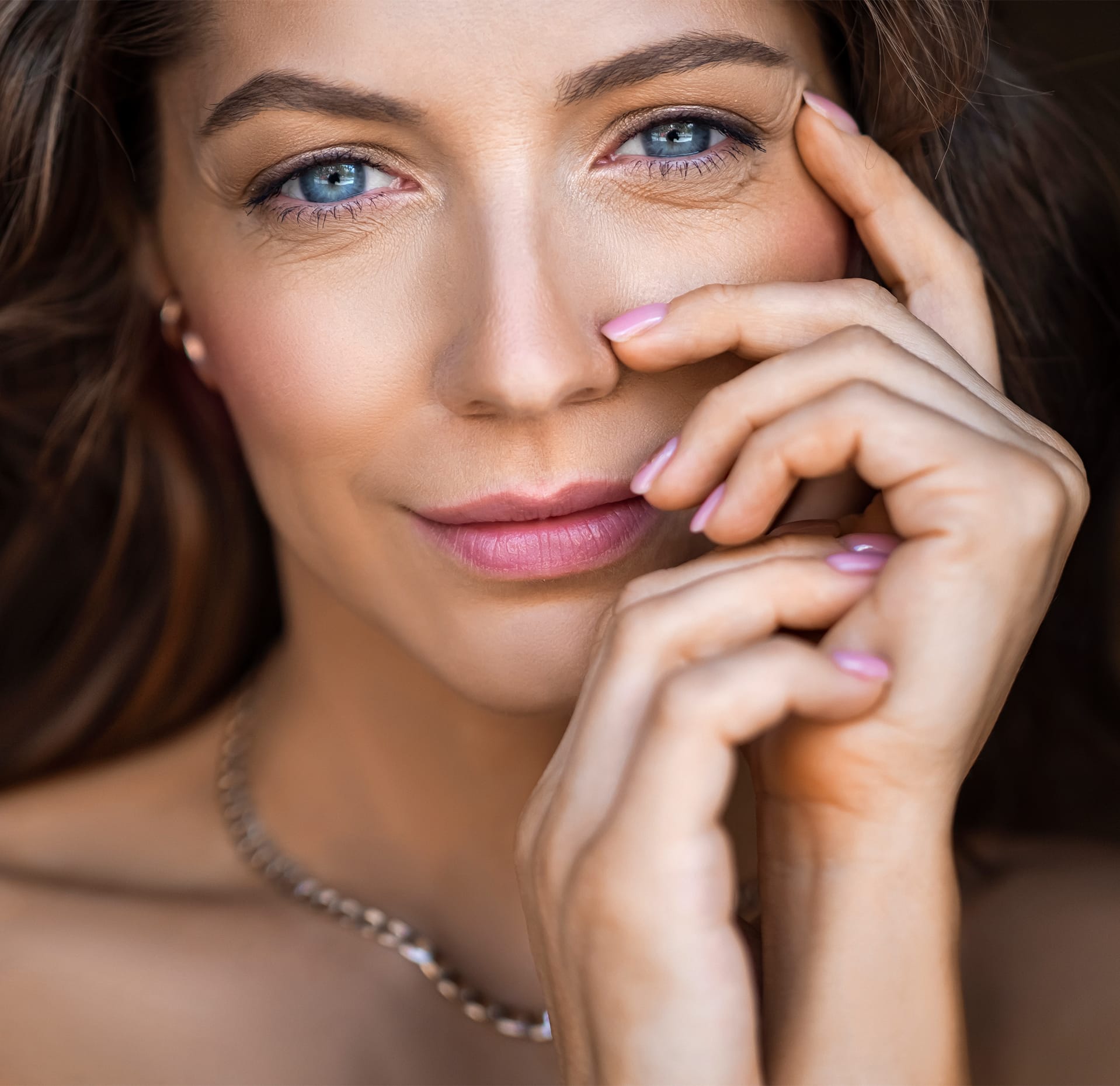 Woman posing with her hands on her cheek