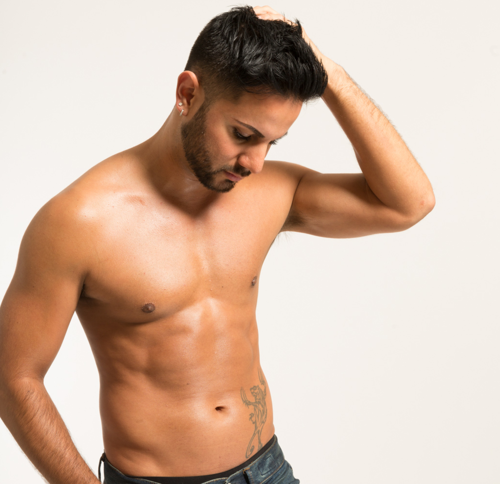 Shirtless man posing with his hand on his head