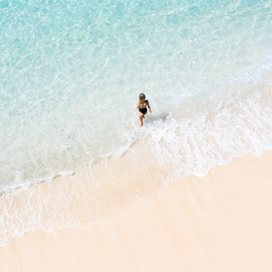 Woman walking into the ocean